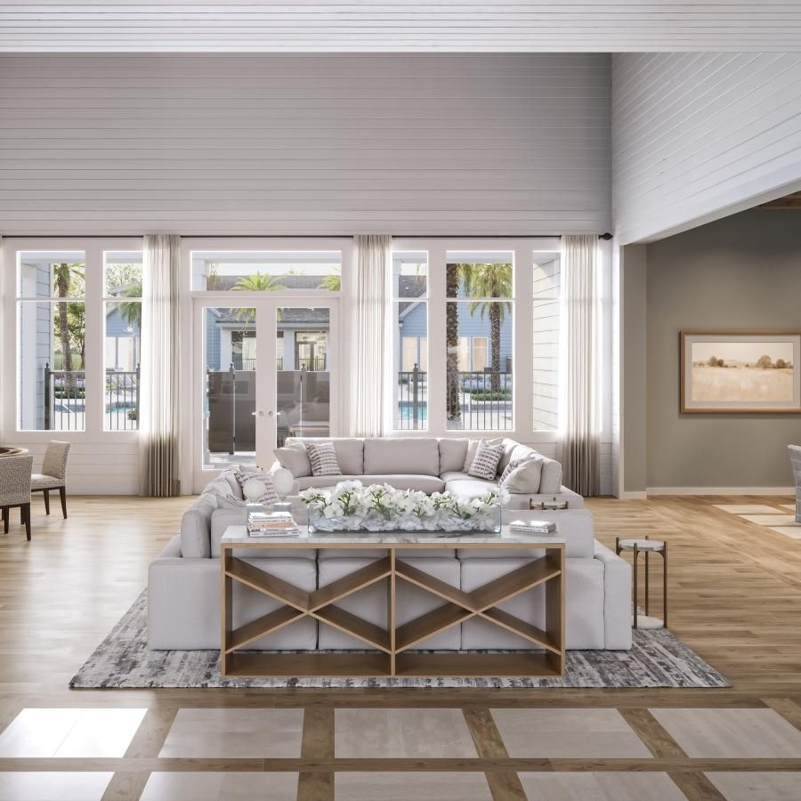 a lounge with couches and wood floors